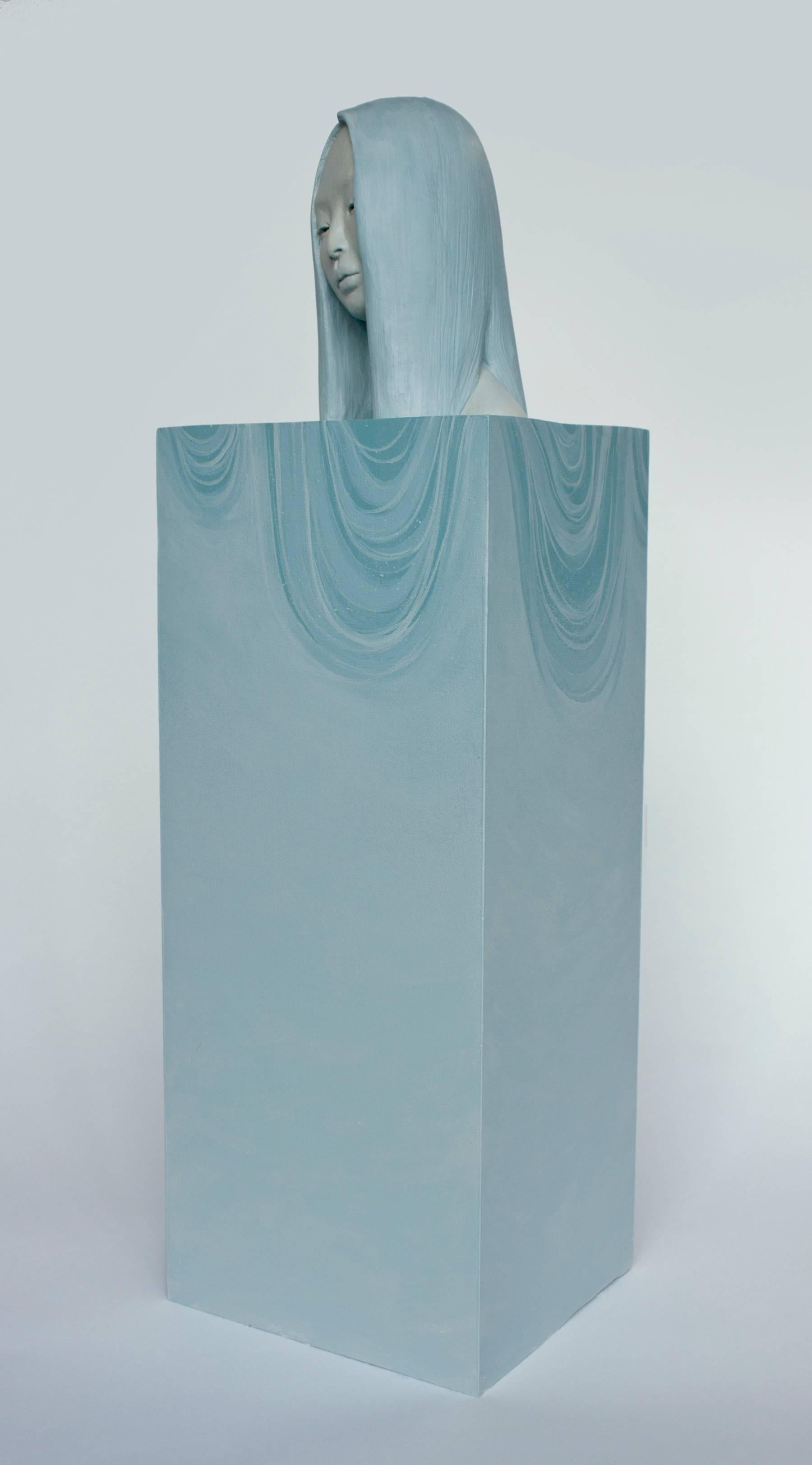 This blue, figurative sculpture titled 