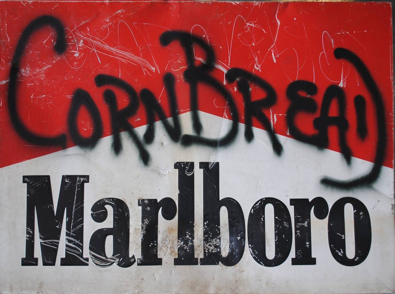Spray paint on a vintage Marlboro sign.

Darryl McCray, known by his tagging name, “Cornbread,” is a graffiti artist from Philadelphia, credited with being the first modern graffiti artist. Darryl McCray was born in North Philadelphia in 1953 and