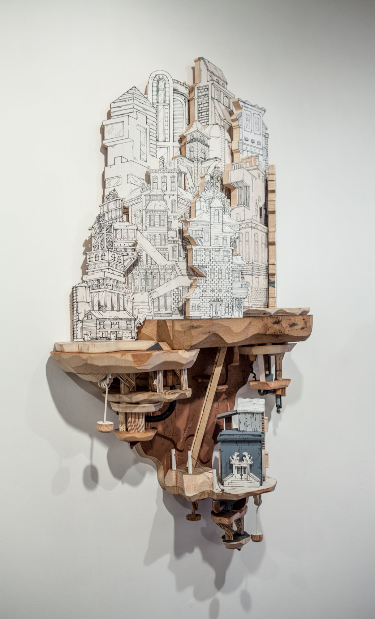 Silkscreen printed wood cut and assembled into three-dimensional sculptures

Artist Statement // My work is about the intersection of built environments and subterranean systems. I create drawings and sculptures of fantastical urban environments.