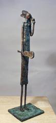 Guitarras, bronze sculpture, vertical, guitar seller, rustic, textured bronze