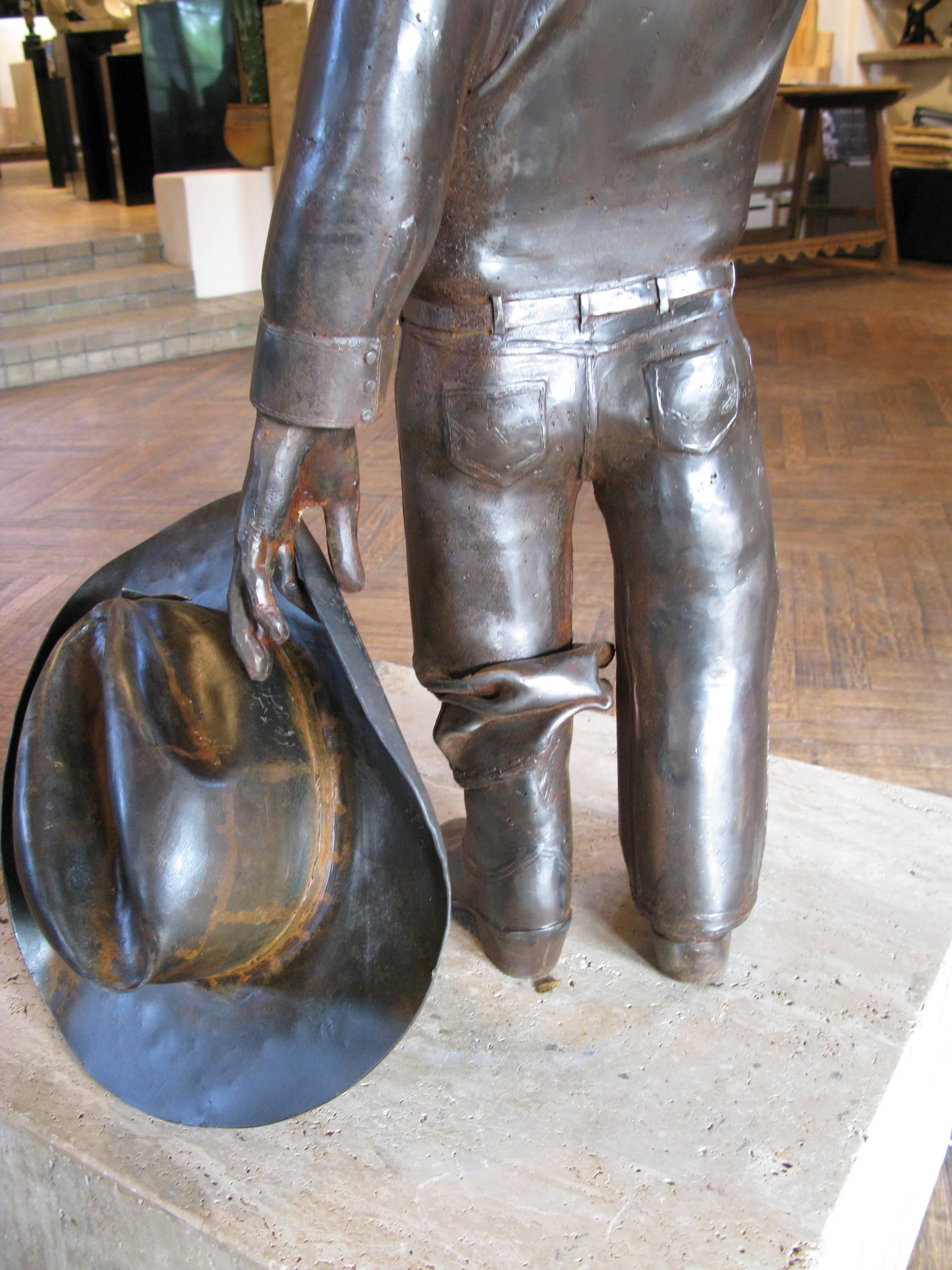 Howdy, by Rodger Jacobsen,  steel sculpture, cowboy, stetson hat, boots, Texas 7