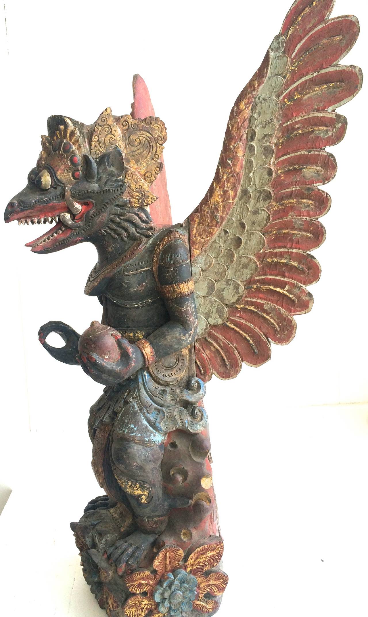 Fabulous and rare hand carved star wood sculpture.
The Garuda is a large bird-like creature, or humanoid bird that appears in both Hinduism and Buddhism. Garuda is the mount (vahana) of the Lord Vishnu.
Original Balinese Garuda temple figure 19th