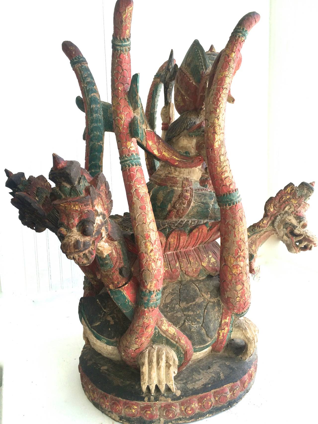 Antique Balinese Wooden Sculpture Vishnu Riding Dragon Serpents.
Rare late 19th century Balinese Temple sculpture, wood polychrome paint, four detachable dragons serpents. Original condition some paint loss.