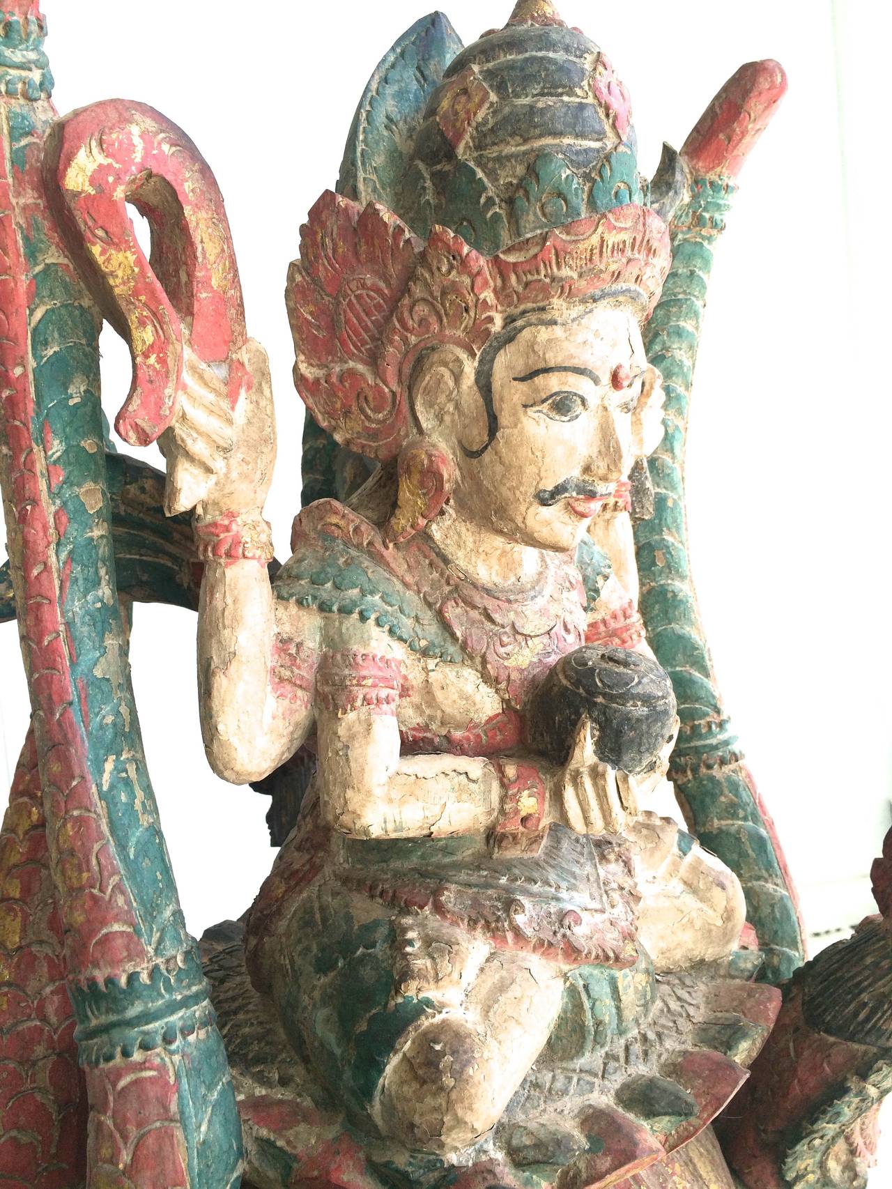 Antique Balinese Wooden Sculpture Vishnu Riding Dragon Serpents.
Rare late 19th century Balinese Temple sculpture, wood polychrome paint, four detachable dragons serpents. Original condition some paint loss.