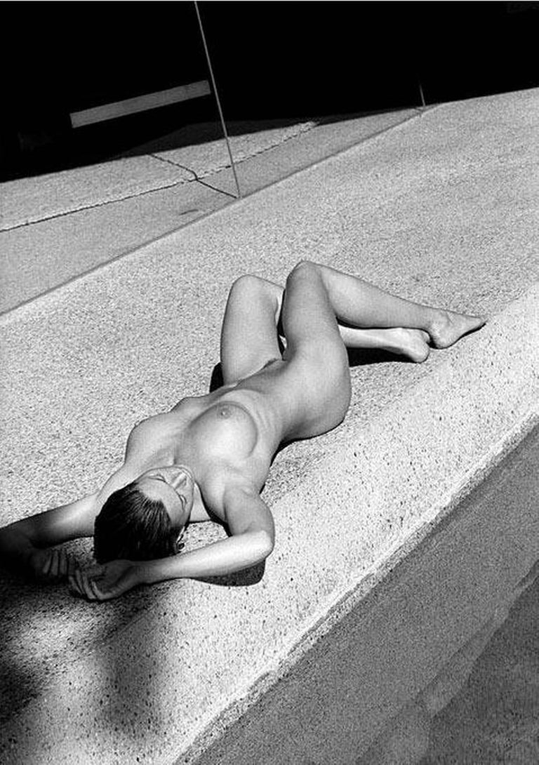 Antoine Verglas Black and White Photograph - Carre Otis 4 - the nude model lying on a side walk in the sun