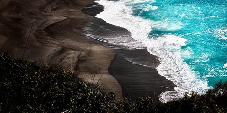 David Drebin Color Photograph - Looking Down - blue sea and bay with grass on the side waves breaking