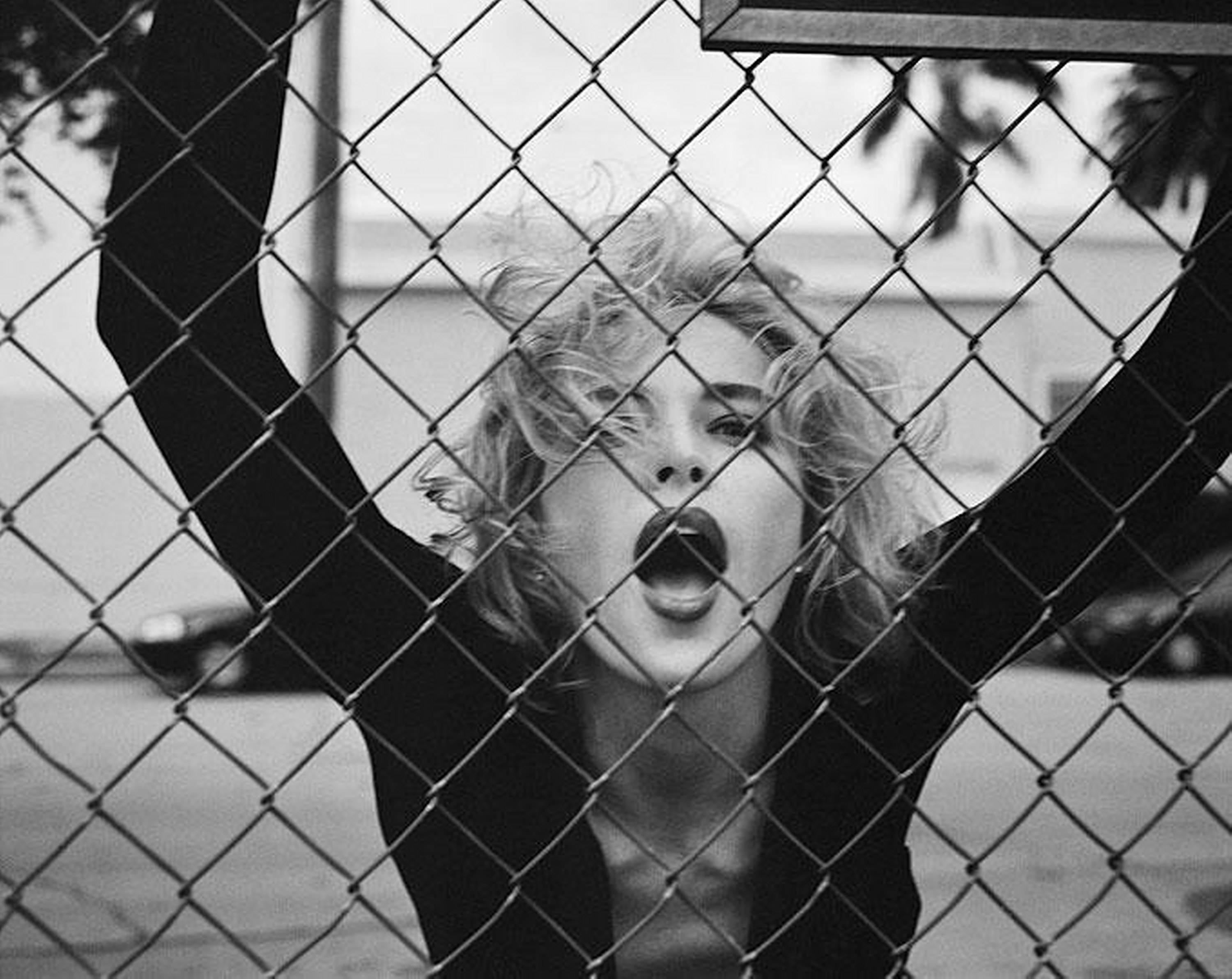 Michel Comte Portrait Photograph - Sharon Stone, Esquire - portrait of the superstar in front of a fence