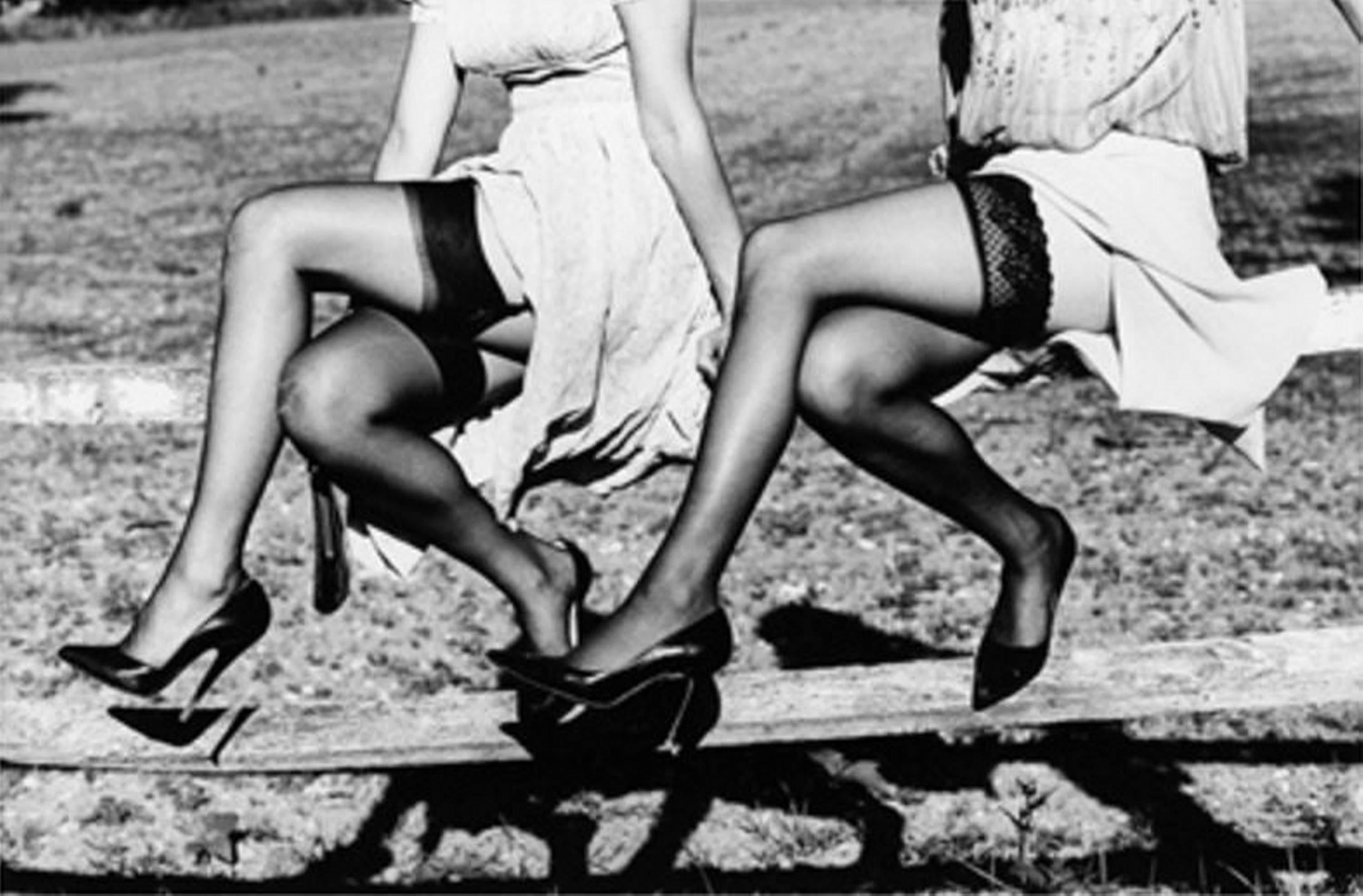 Leg Show II - Models in Stockings sitting on a fence, fine art photography, 2002