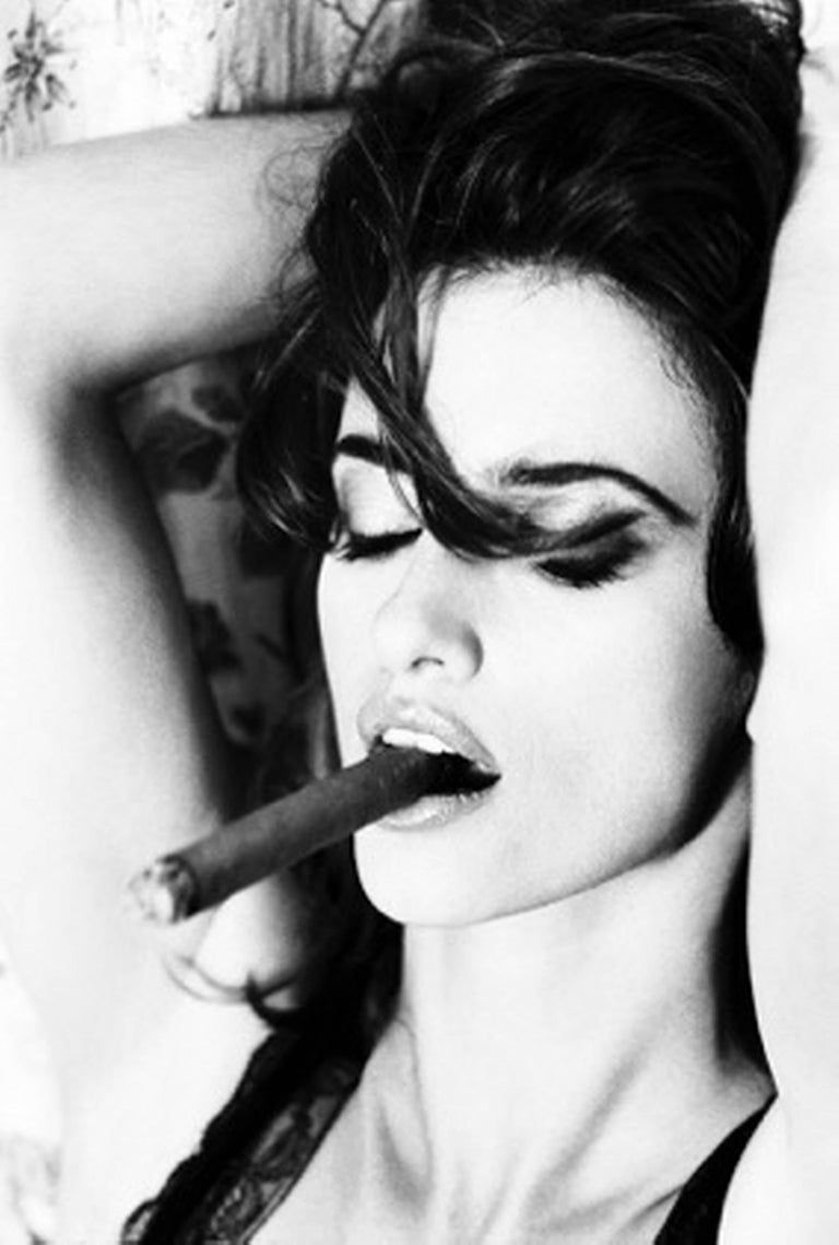 Ellen von Unwerth Figurative Photograph - Penelope Cruz smoking Cigar - the actress posing with her arms behind her head