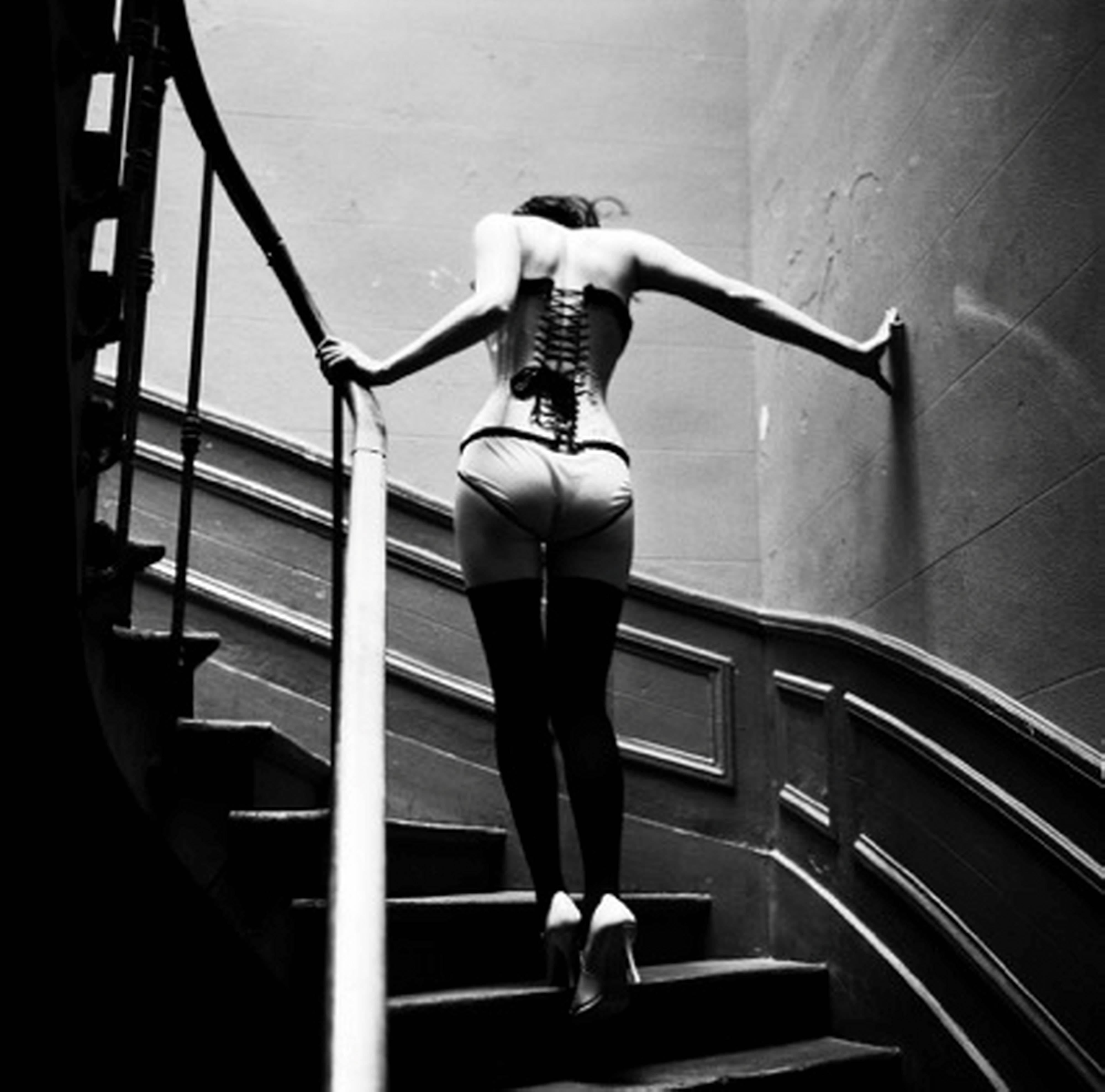 Ellen von Unwerth Black and White Photograph - Upstairs, Paris - Model in Lingerie walking up Stairs, fine art photography 1996