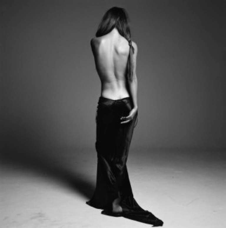 Michel Comte Nude Photograph - Helena Christensen - the supermodel standing in a black dress with back shown