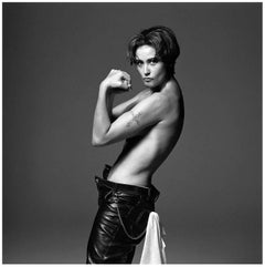 Demi Moore - model posing topless in leather pants, black-and-white photograph