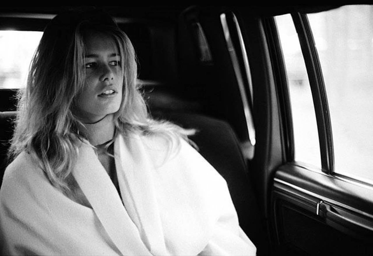 Antoine Verglas Black and White Photograph - Claudia Schiffer - the young supermodel sitting in a car wearing a white coat