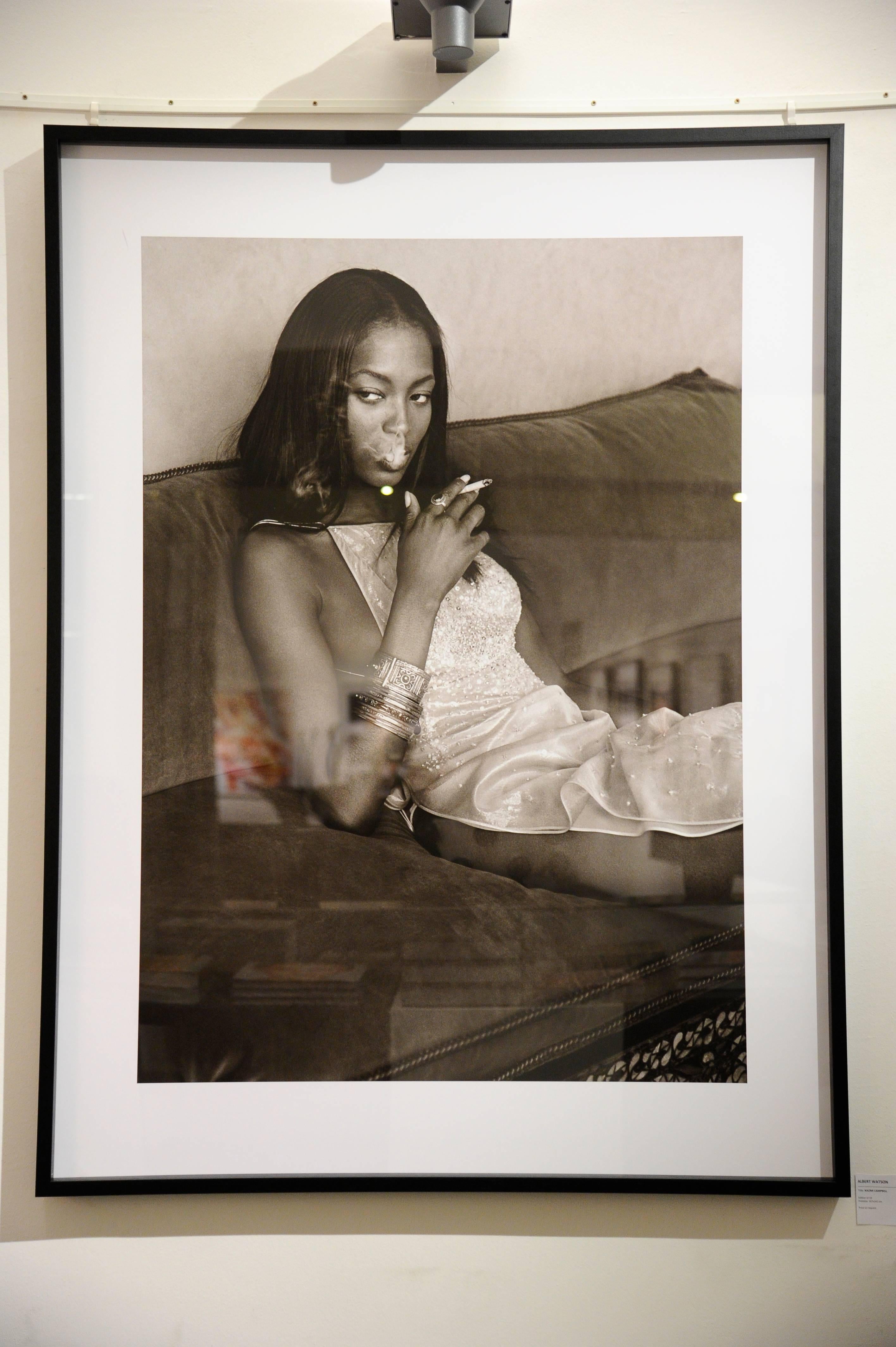 Naomi Campbell - the supermodel smoking while sitting on a sofa - Photograph by Albert Watson