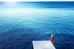 Jumping into the Blue - blue ocean and woman jumping from bridge