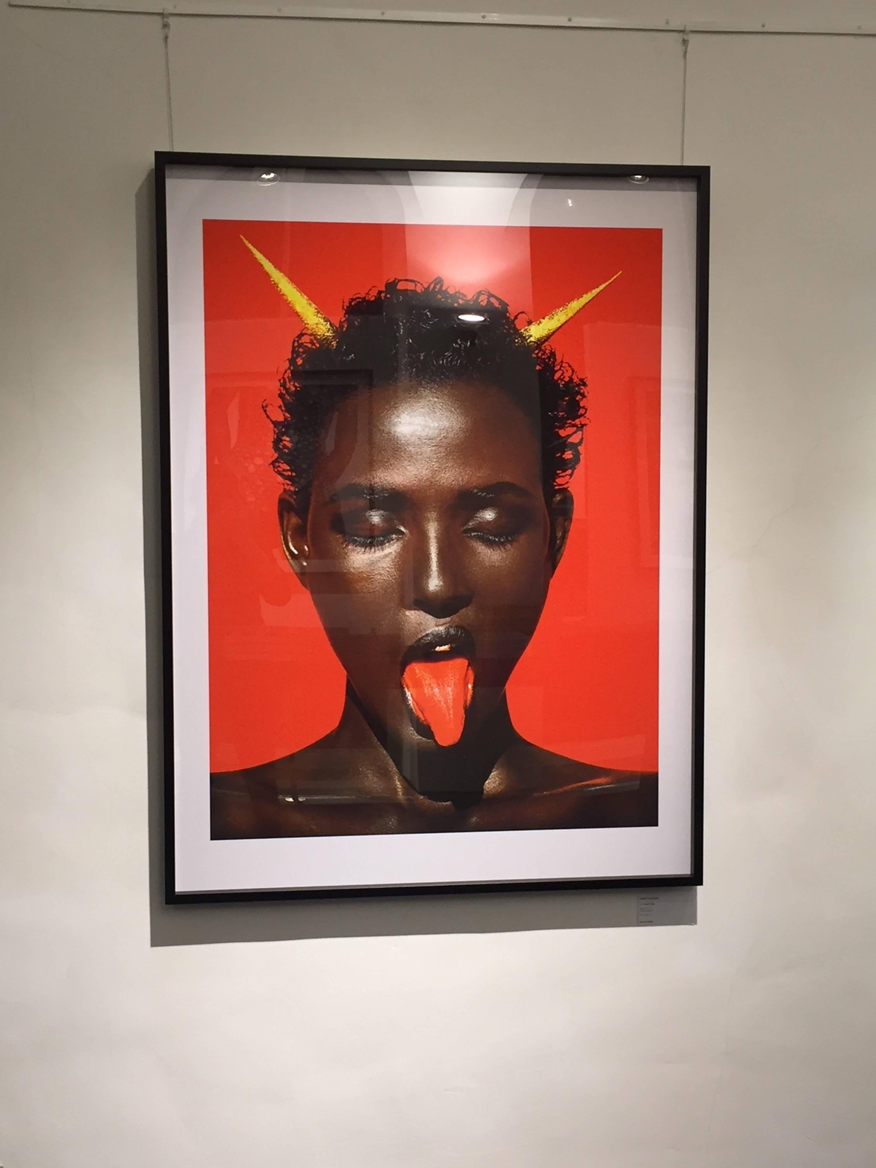 Waris Dirie Marrakech - iconic supermodel with red in the background - Photograph by Albert Watson