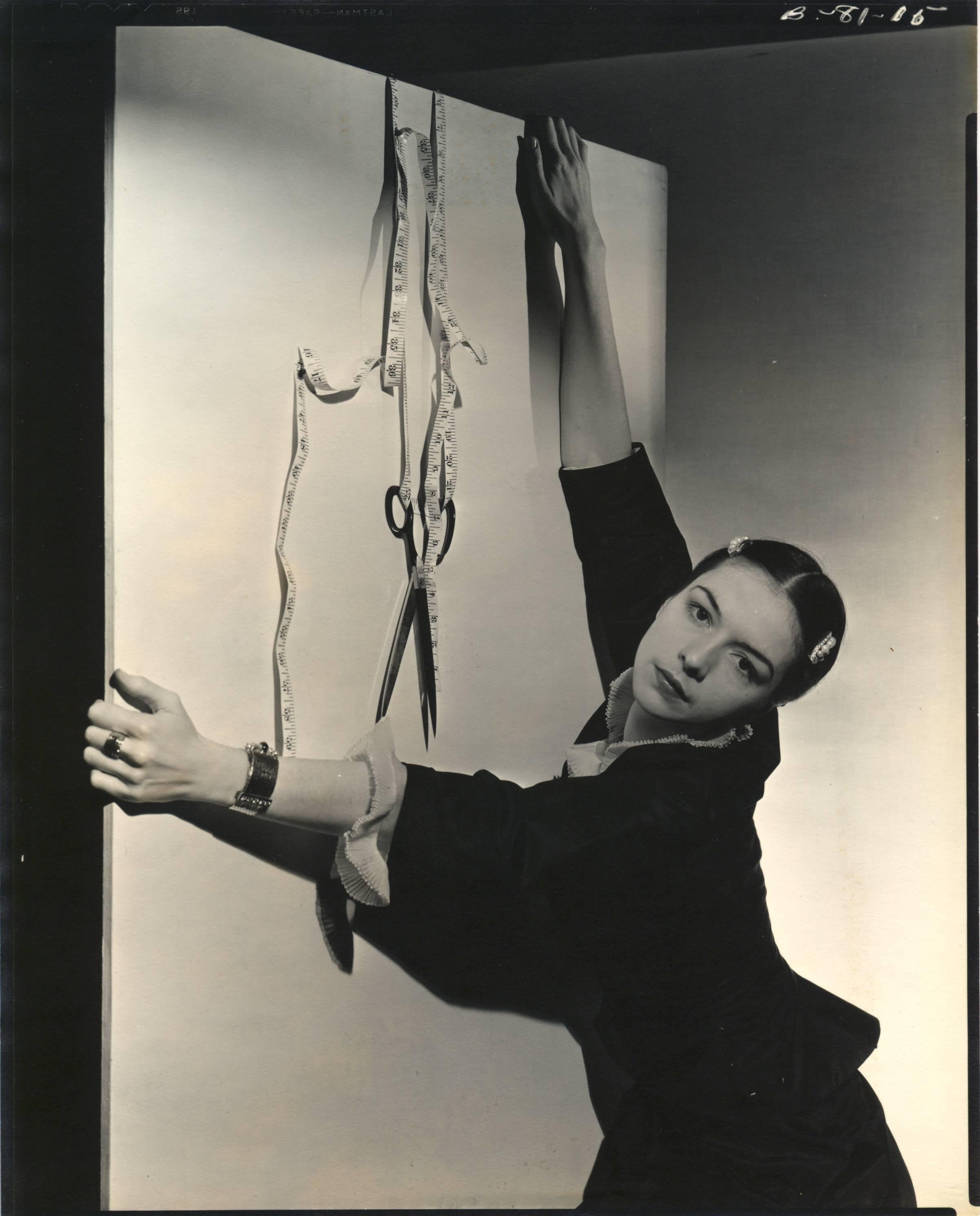 Cecil Beaton Figurative Photograph - Surreal Vignette, Ruth Ford with tapemeasure.