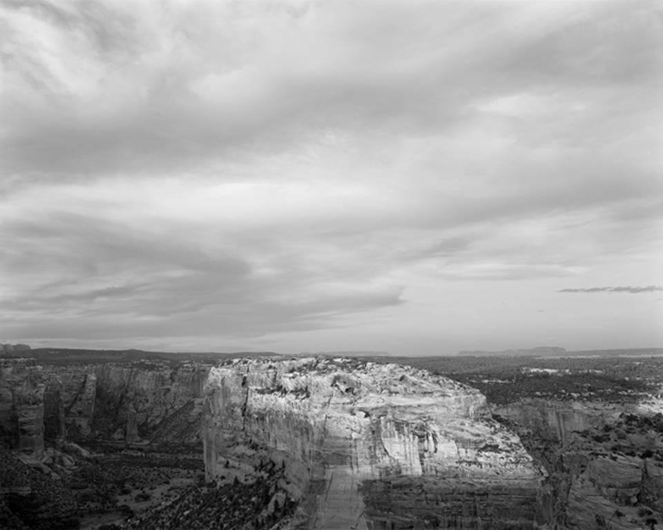 Jack Ridley Black and White Photograph - Sunlit Rim and Clouds, Canyon de Chelley