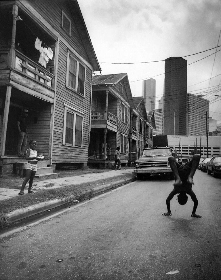 Earlie Hudnall Jr. Black and White Photograph - Flipping Boy, 4th Ward, Houston, TX by Earlie Hudnall, Jr., 1983