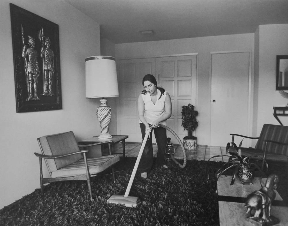 Bill Owens Black and White Photograph - Untitled (Woman Vacuuming), from Suburbia