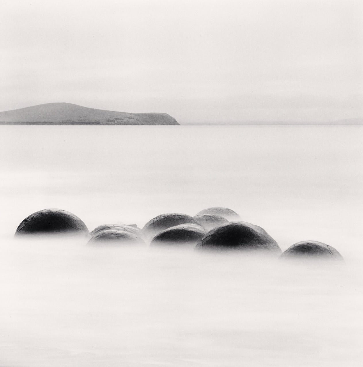 Michael Kenna Black and White Photograph - Nine Concretions, Koekohe Beach, Moeraki, New Zealand