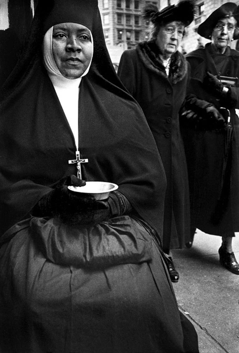 Harold Feinstein Black and White Photograph - Nun Hoping for Charity from People Passing, NYC