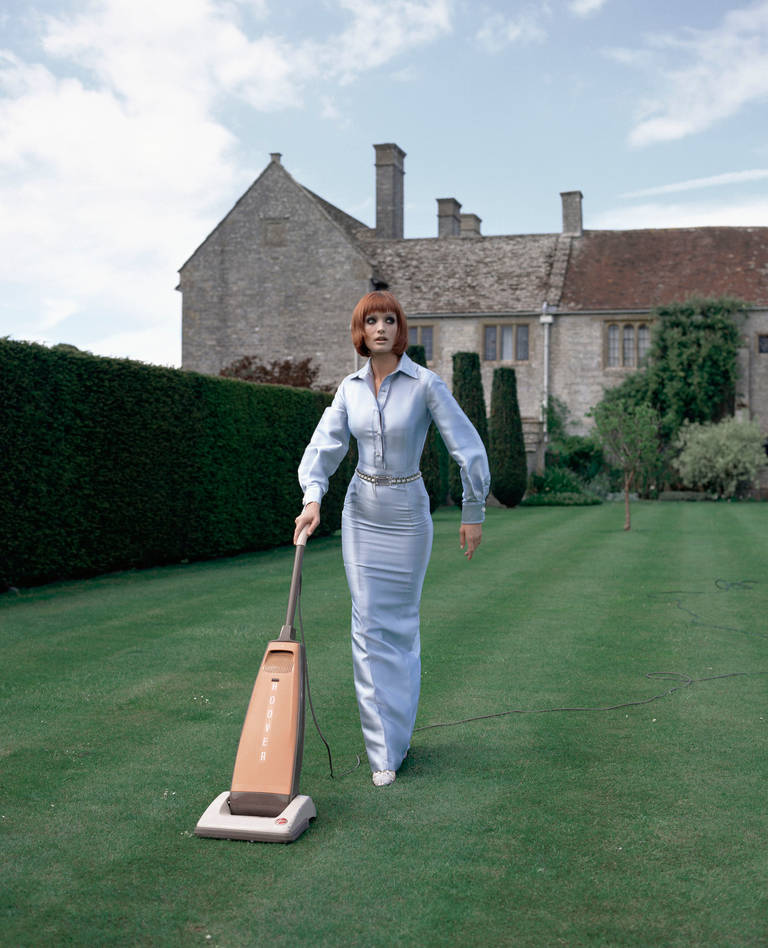 Geof Kern Color Photograph - Untitled (Model Hoovering the Lawn)