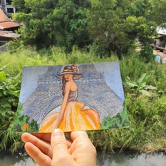 Woman in Orange Gown and Wide-Brim Hat by Eiffel Tower
