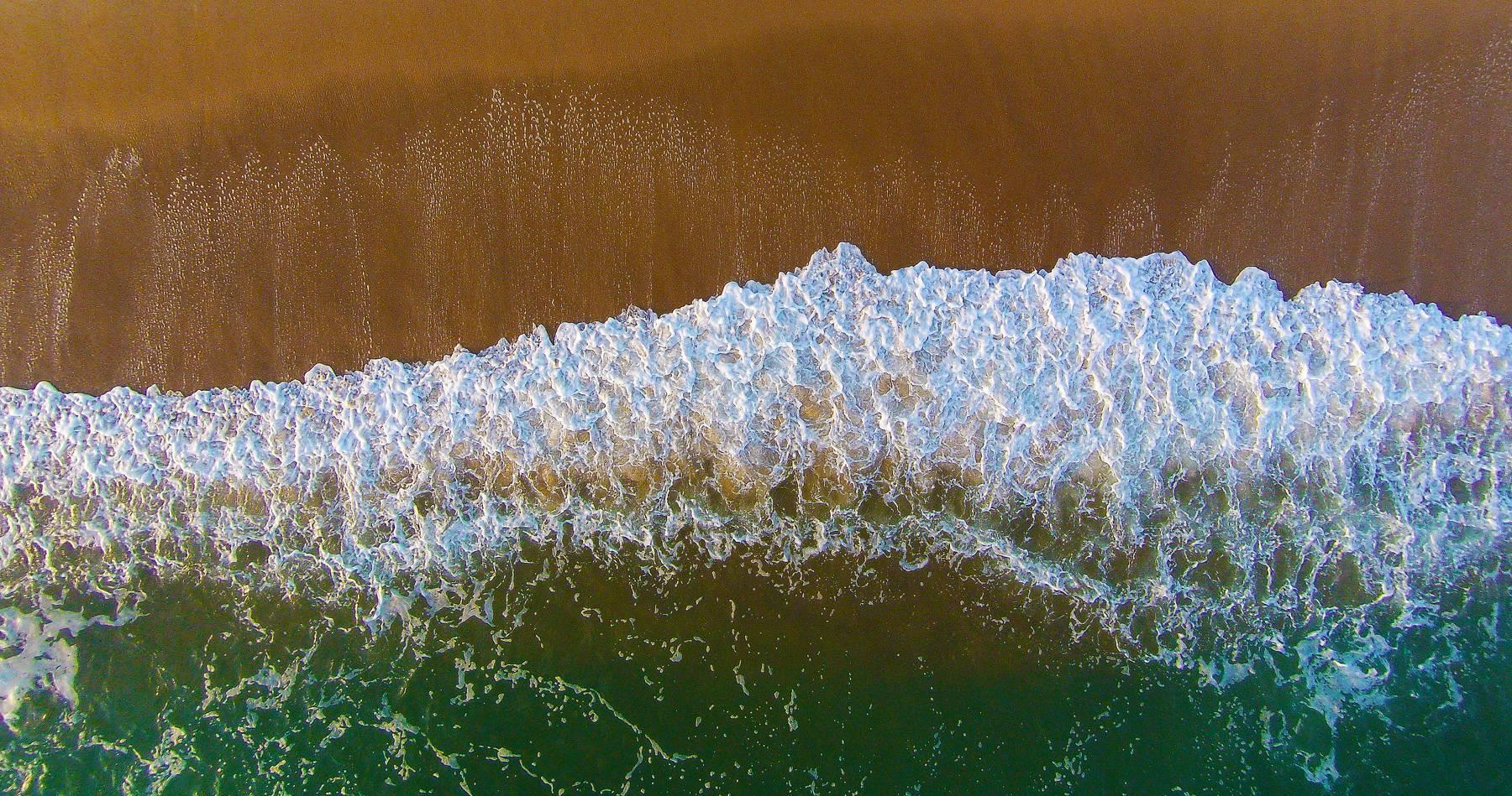 Albert Delamour Landscape Photograph - Aerial view of the beach, wave