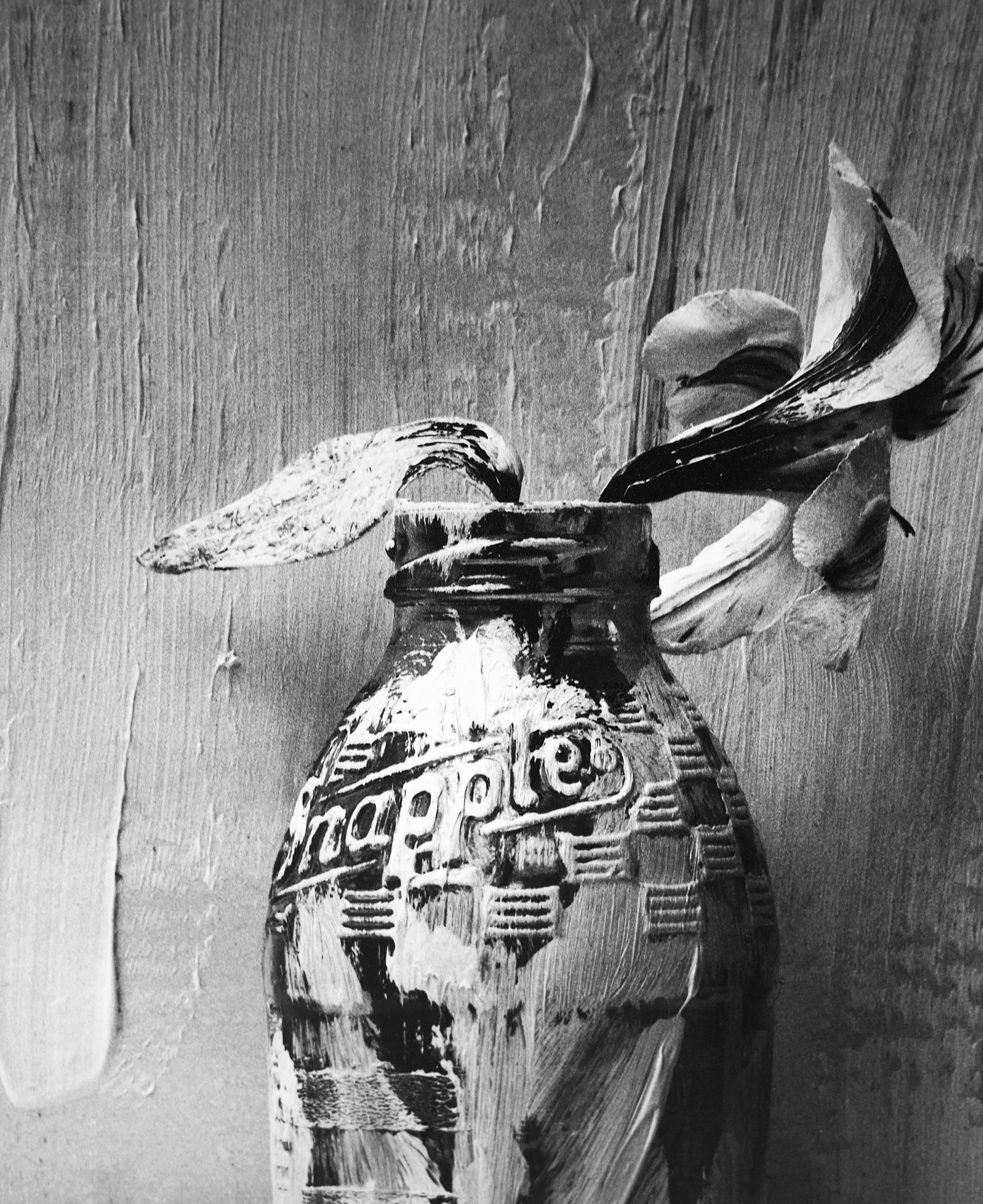 Picture of Painted Bottle with Flower, Black and white Still life photography - Modern Photograph by Alexandra Catiere