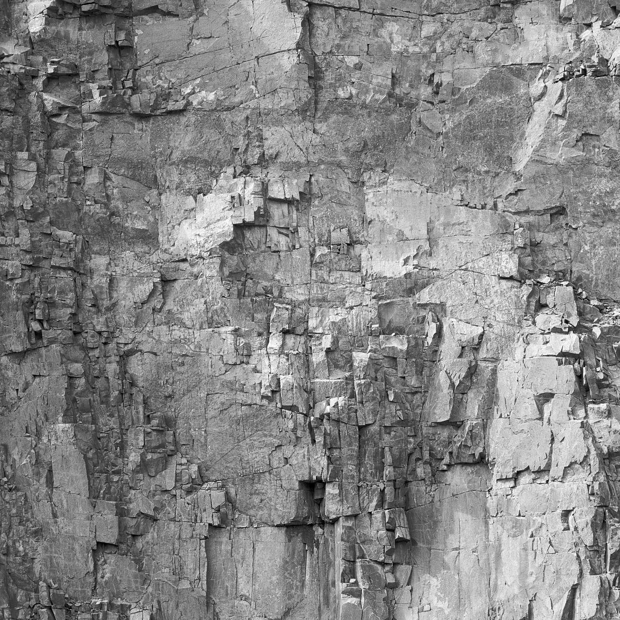 Andrew Buck Black and White Photograph - Rockface 30: Large Square Black & White Photograph of Graphic Jagged Rock Cliff