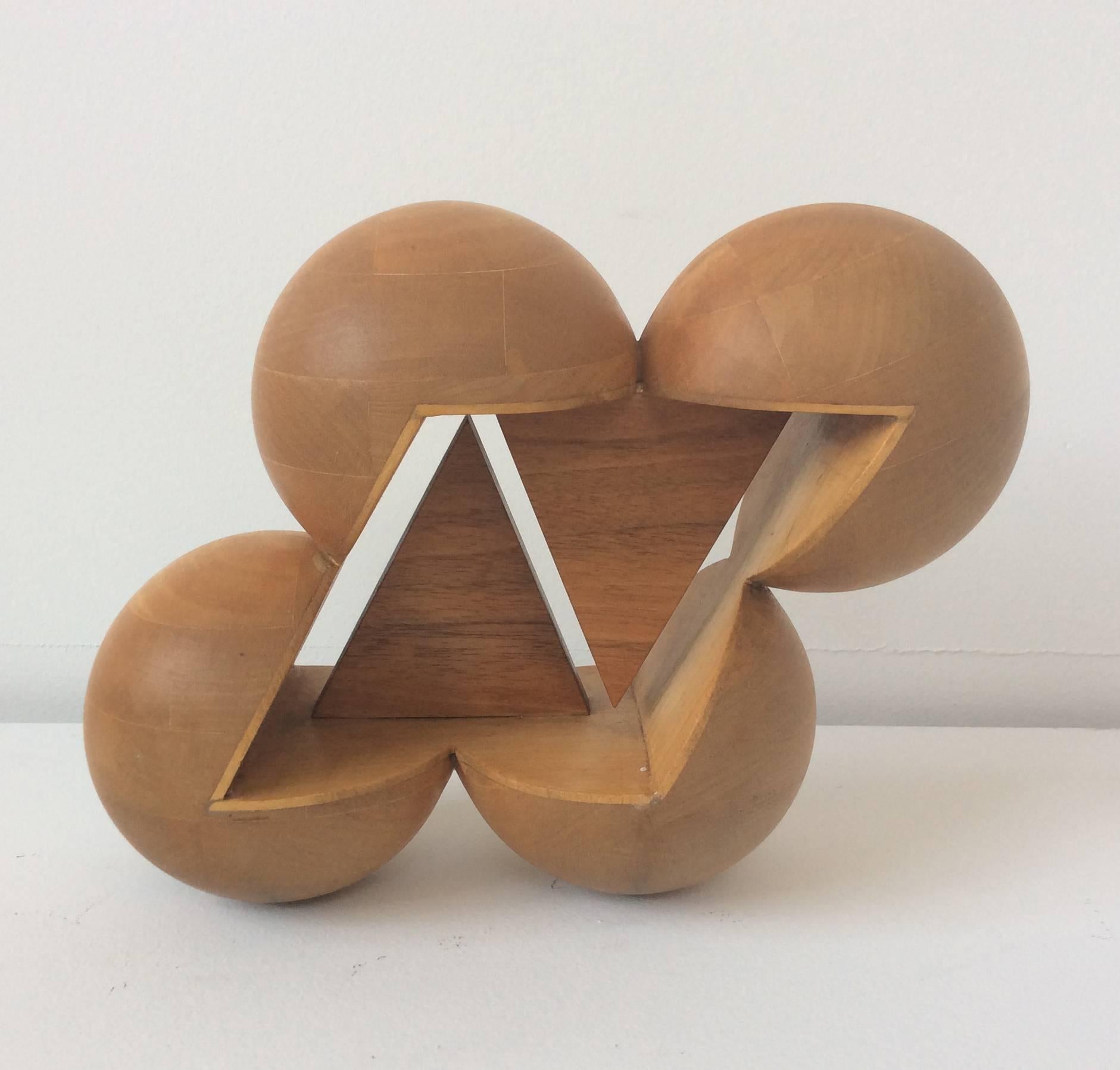 Abstract, mid century modern style small wooden table sculpture 
8 x 6 x 4 inches, wood

Inspired by the sleek mid century modern designs and use of organic materials, this small scale wooden sculpture is constructed of several round balls that
