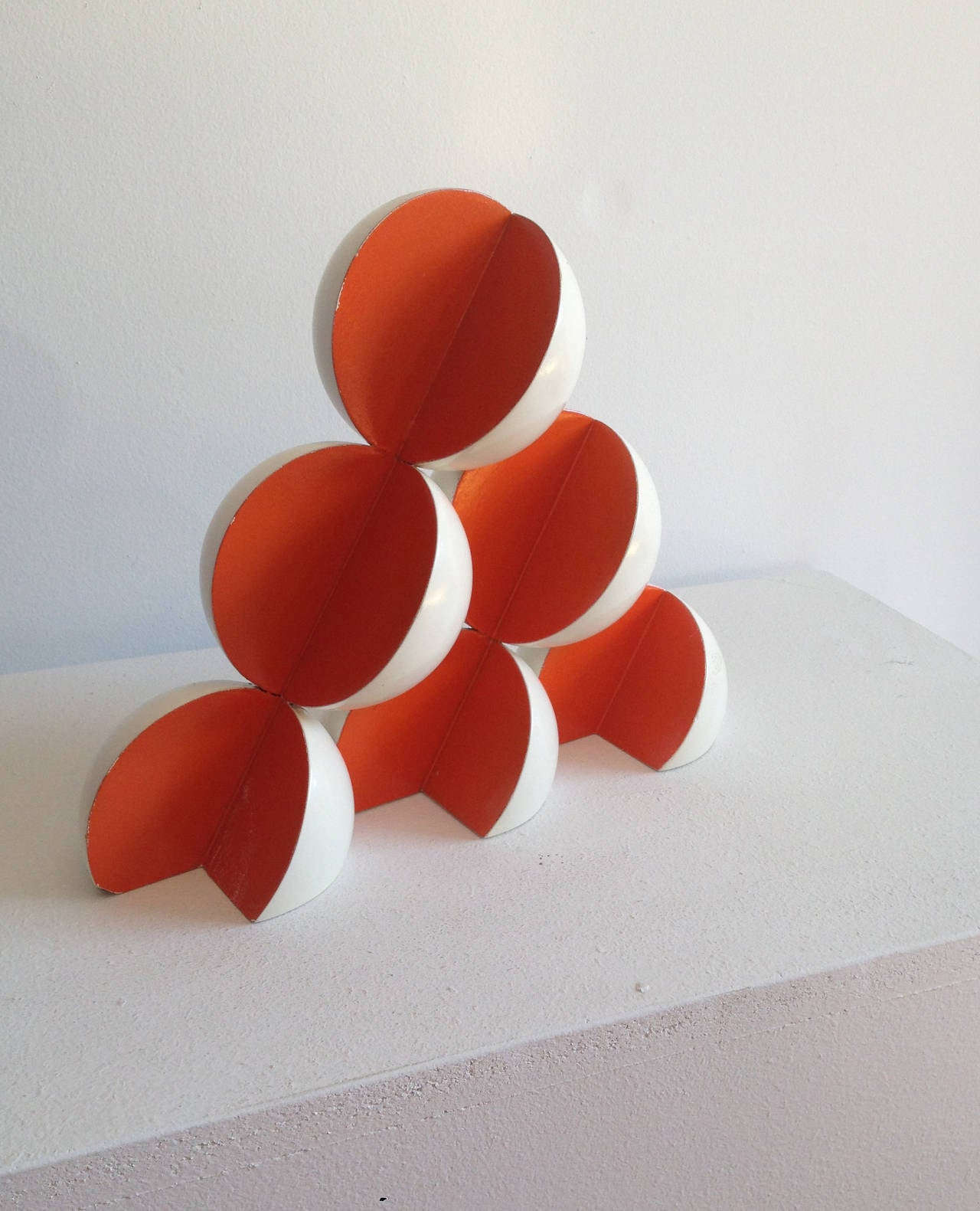 Red & white abstract sculpture in mid century modern style
9 x 11 x 3 inches
painted wood 

This small, contemporary abstract sculpture made of brightly painted wood is perfectly suited for a tabletop, pedestal, or mantle piece. Curved pieces of red