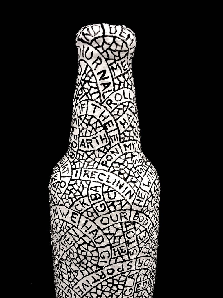 Plaster, sand, & paint on found object
8 x 2.5 x 2.5

This black and white sculpture was created by Hudson Valley-based artist Paul Katz, whose process involves coating found objects in plaster, sand, & paint. The inscription which coats the surface