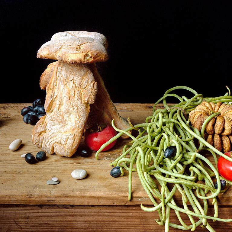 Bread House (Framed Food Still Life Photograph of Bread, Vegetables & Stones)  - Black Still-Life Photograph by David Halliday