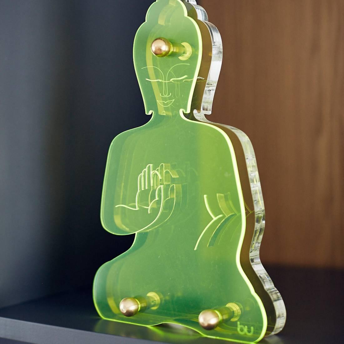This  Green neon Buddha statue, is 2 layers of laser cut Plexiglas joined together by brass industrial elements.
A unique Buddha sculpture, designed as an everyday reminder to live a compassionate and mindful life.
Influenced by both urban