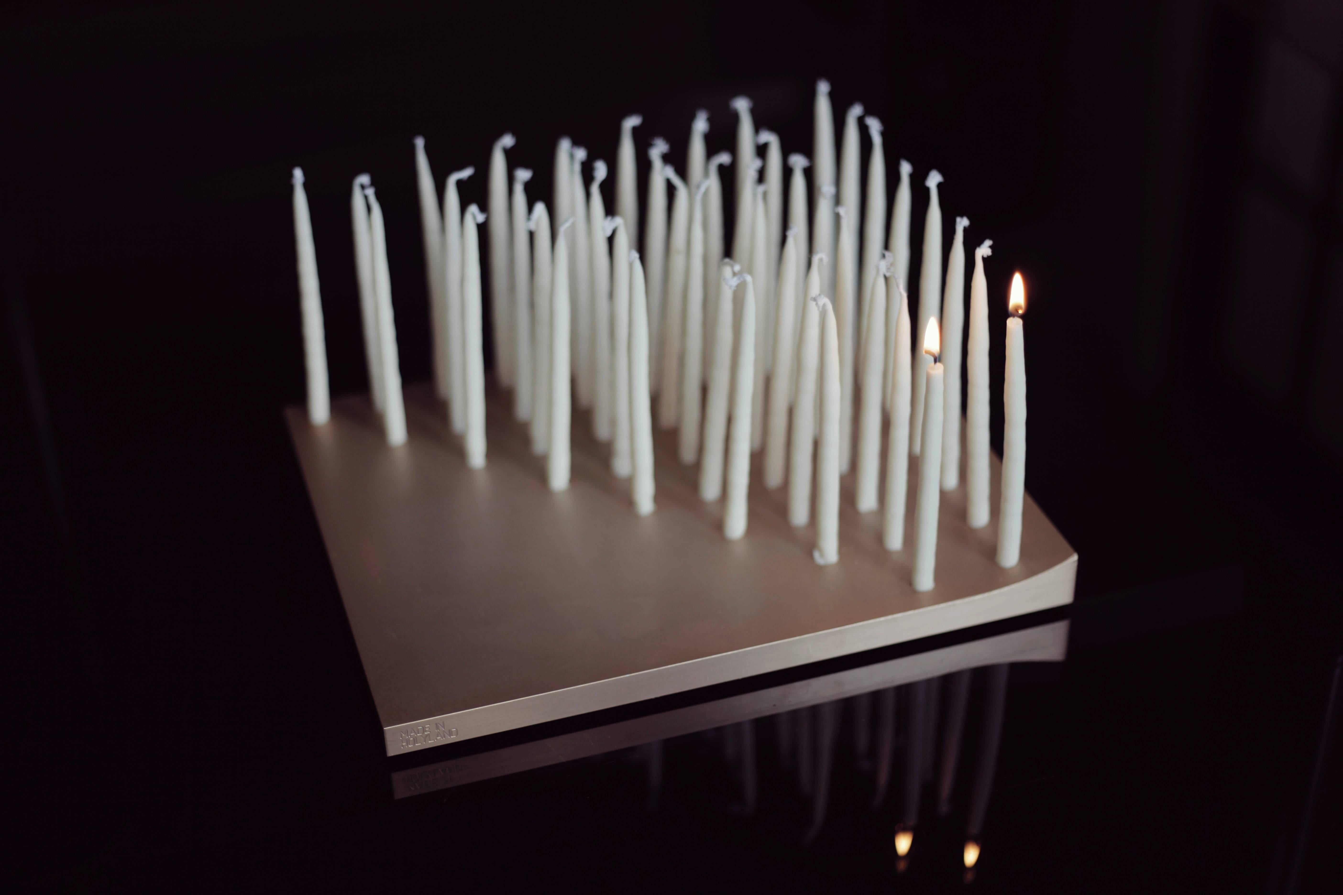 Alon Seifert is a designer, writer, mixed media artist and a great believer in causes he believes in. LUMEN44 is Alon's take on the centuries old Menorah design. It is made of a 6lbs. slab of anodized aluminum, with eight rows of CNC drilled holes,