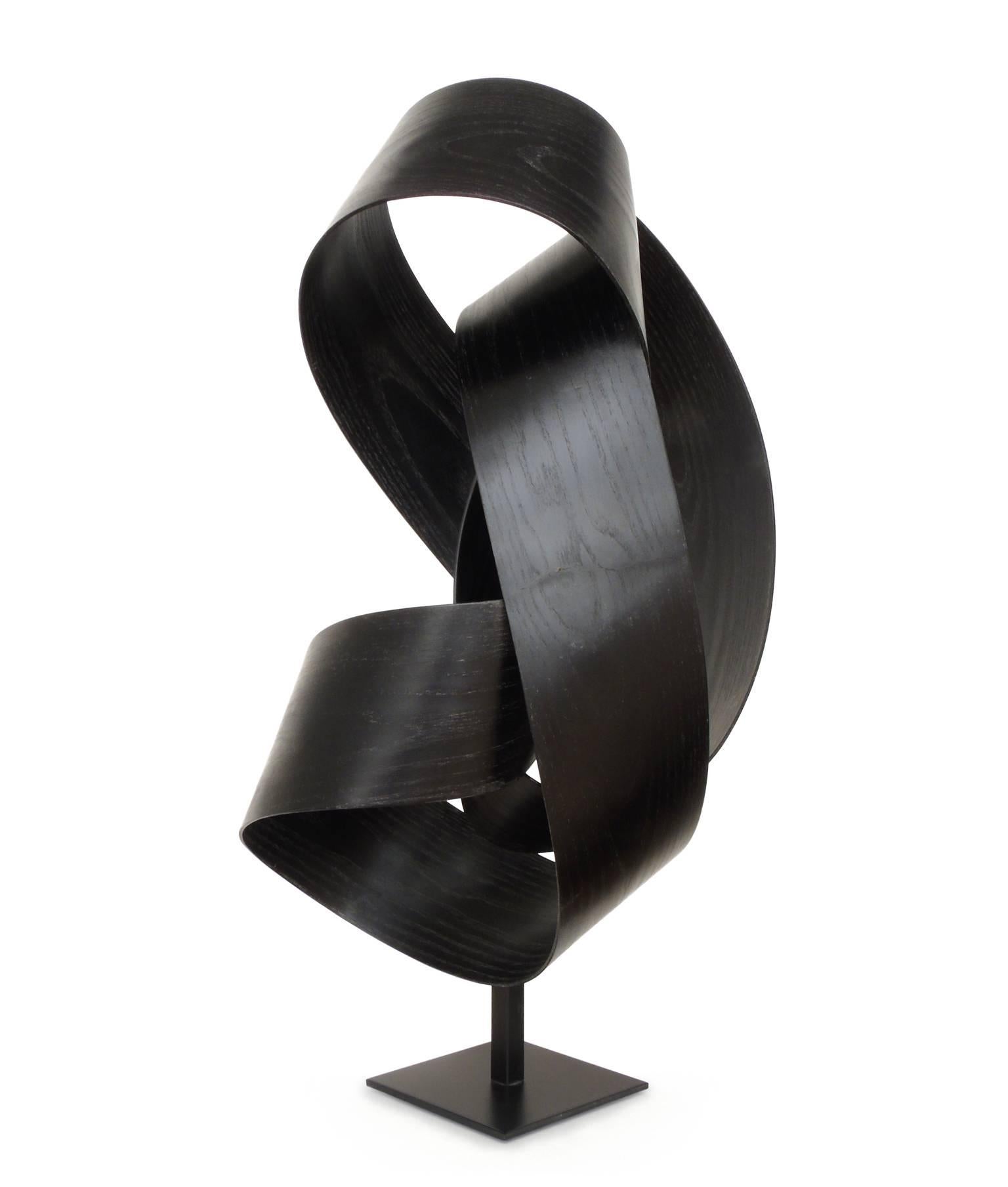 This black ribbon of wood is a nice example of work by sculptor Jeremy Holmes whose bentwood creations range in scale from modestly sized free standing sculptures to gravity defying installations of wood ribbons over a quarter mile in length.