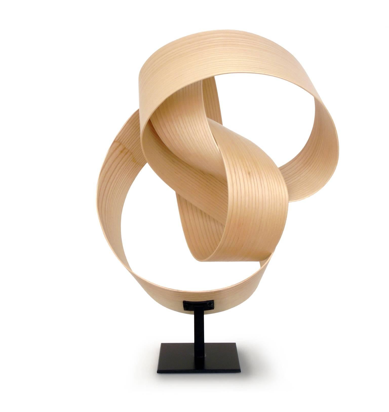 Jeremy Holmes' lyrical works range in scale from modestly sized free standing sculptures to gravity defying installations of wood ribbons over a quarter mile in length. Atmosphere #205 has a clean contemporary look in light natural colored wood. It