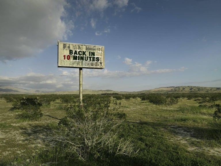 Frank Schott Color Photograph - Back in 10 - large format photograph of conceptual message sign in landscape
