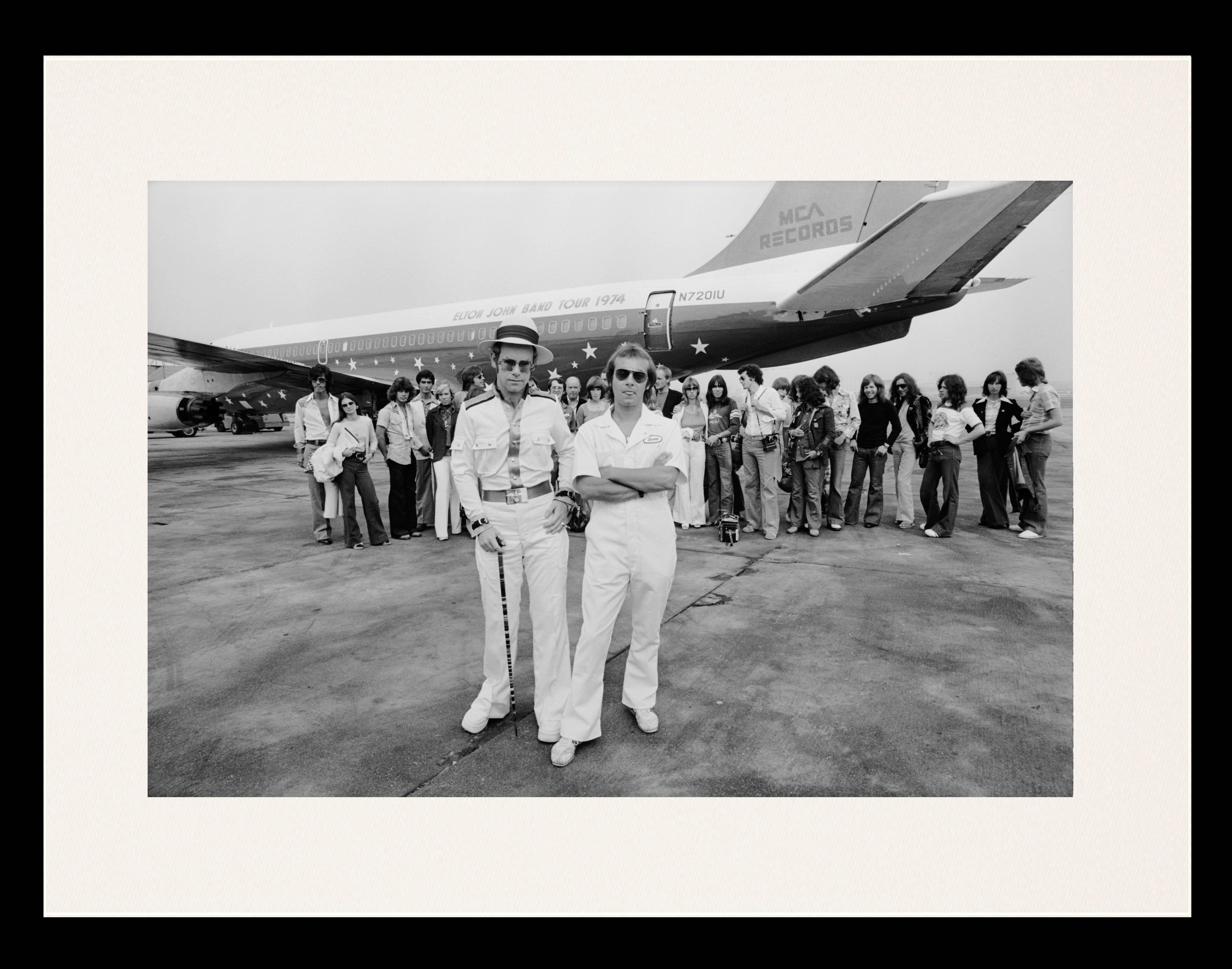 Terry O'Neill Black and White Photograph - Elton John Aeroplane (Framed)