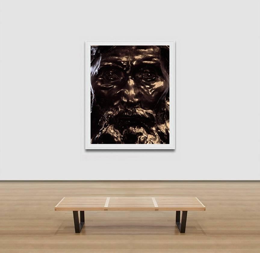 Pierre Sernet's F003, French, Bronze is a 61 x 50 inches Giclée Print. It is framed. The image is a close-up photograph of a bronze sculpture by French sculptor Auguste Rodin, only the face can be seen. The artwork is part of the “Face” series,