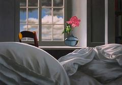 Unmade bed with pink rose