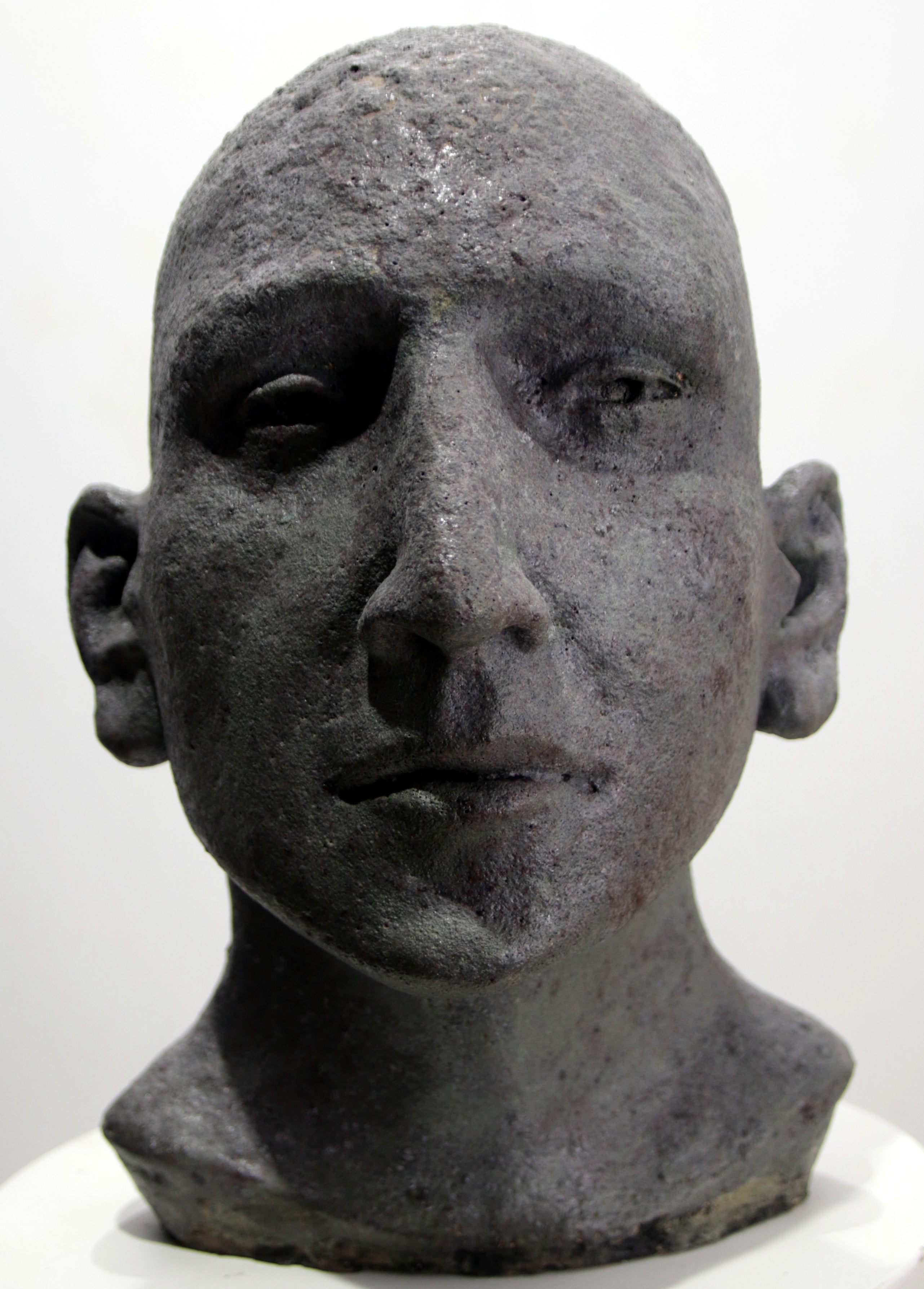 Dark Grey Ceramic Head with Deep-Set Gaze, Textured Glazed Figurative Sculpture