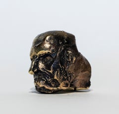 Archaische Taschen-Kopfskulptur aus dunkelpatinierter Bronze mit goldenen Akzenten