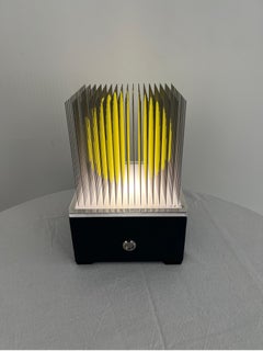 Small yellow kinetic sphere op art, optical art