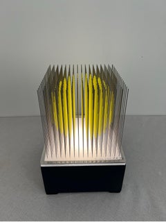 Small yellow kinetic sphere op art, optical art