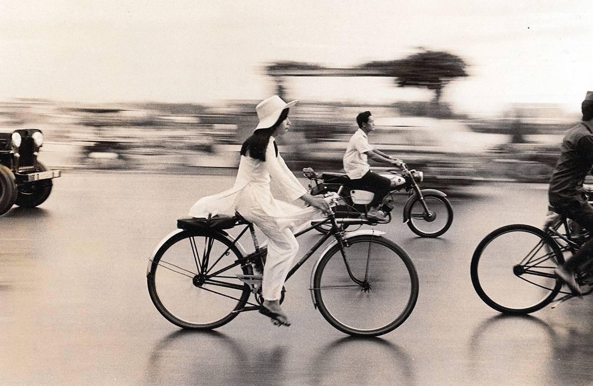 Raymond Depardon Black and White Photograph - Girl on Bicycle, Saigon, 1972 Original press print