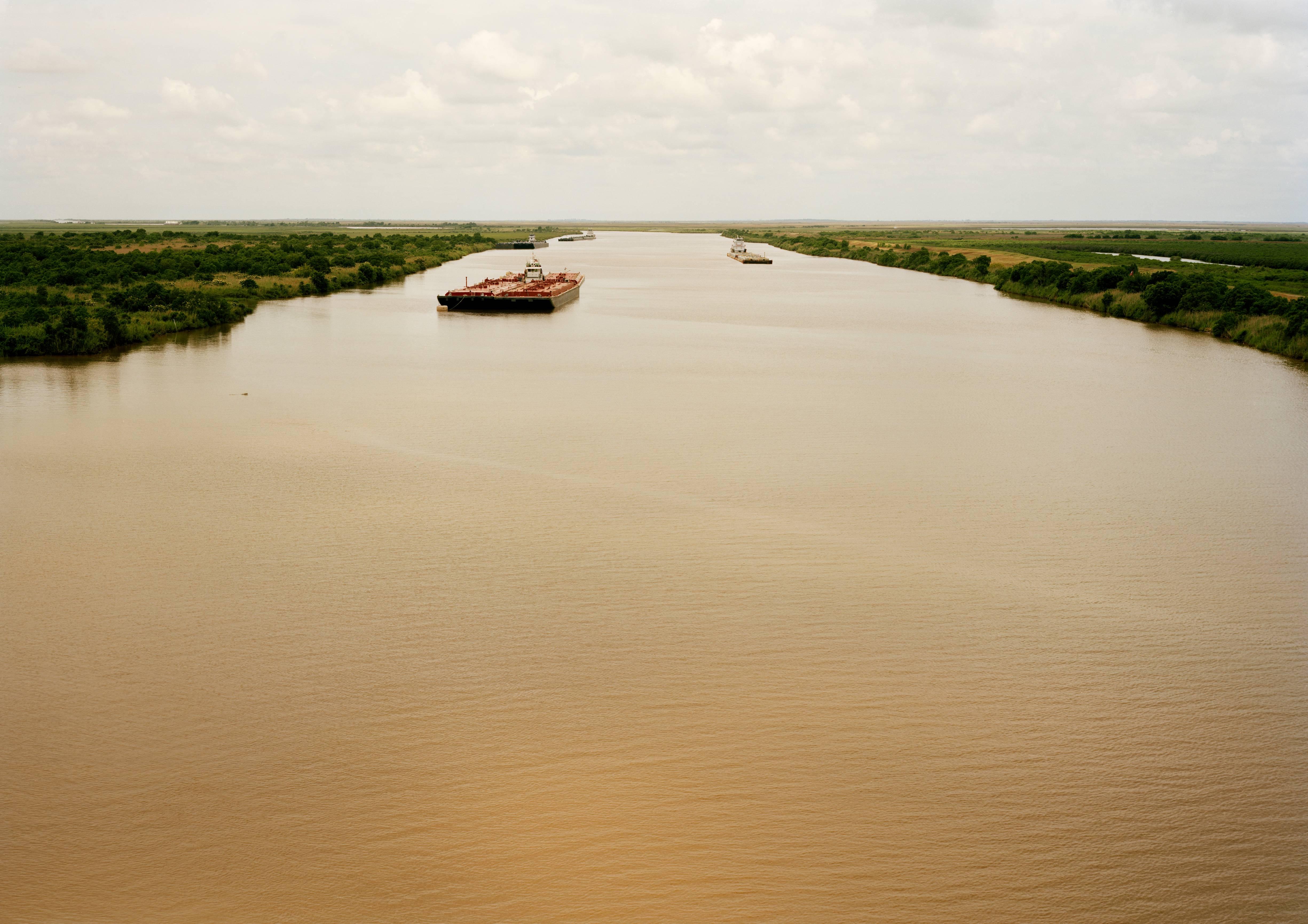 Victoria Sambunaris Landscape Photograph - Untitled (Intercoastal Waterway with Red Barge), Bolivar Peninsula, Texas