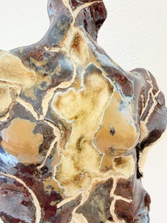 Gaia. Emergence Series. Amber-toned ceramic sculpture with a feminine essence